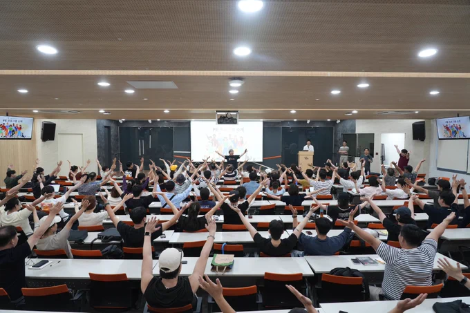 A PE Ambassador presents in a classroom to 250 people about the PE Program.