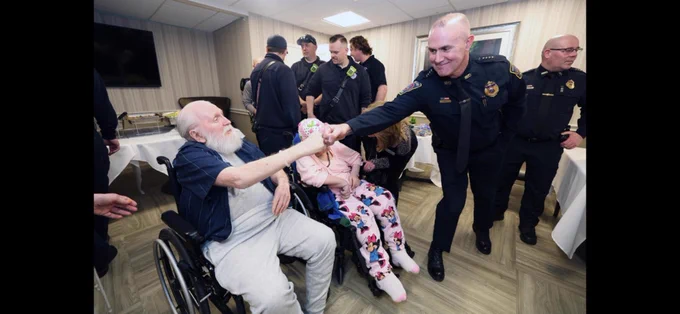 Robert Williams bumps fists with Rockland Police Chief Nicholas Zeoli. Credit: Marc Vasconcellos/Brockton Enterprise