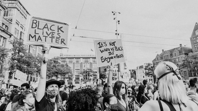 Protesters rally in Amsterdam with signs supporting the Black Lives Matter movement.
