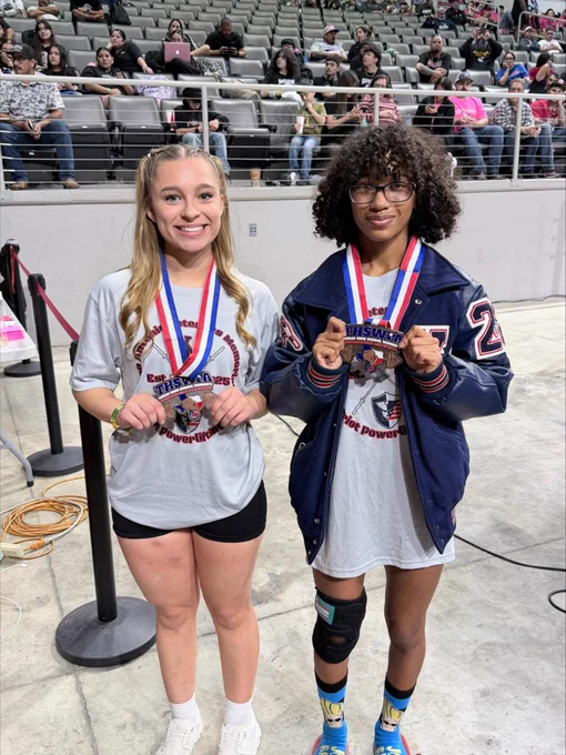 Jeruzalem and Ailani posing with their medals