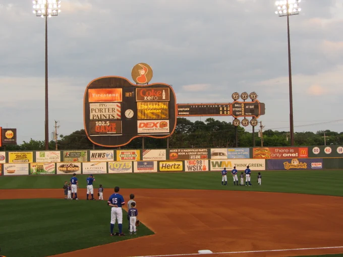 Photo: View of giant guitar-shaped scoreboard over baseball field