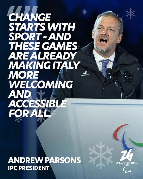 An individual speaking at a podium with the IPC logo, wearing a dark jacket. The backdrop features snowflakes and a Milano Cortina 2026 logo. The text on the image reads: "Change starts with sport - and these games are already making Italy more welcoming and accessible for all." Below is the name Andrew Parsons, IPC President.