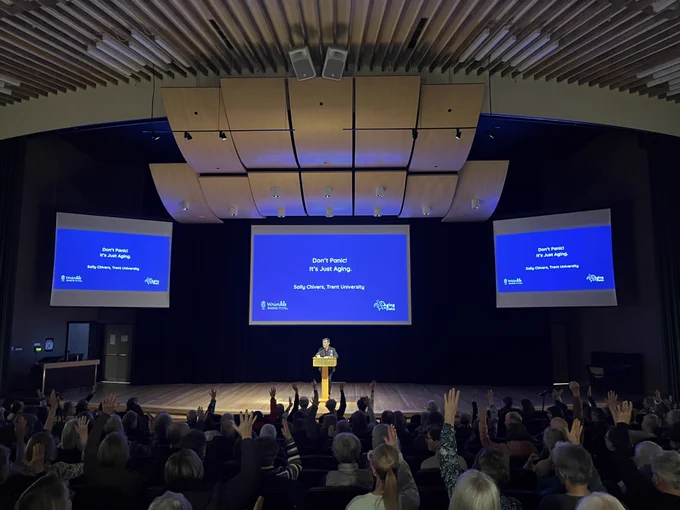 Photo of Dr. Thomas Hadjistavropoulos, Director of the University of Regina's Centre on Aging and Health (CAH), introducing the 2025-2026 CAH Distinguished Public Lecture speaker, Dr. Sally Chivers (Trent University).