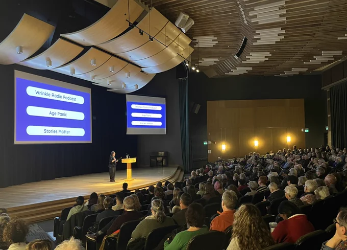 Photo of the 2025-2026 Centre on Aging and Health (CAH) Distinguished Public Lecture Speaker, Dr. Sally Chivers (Trent University), delivering her lecture, "Don't Panic! It's Just Aging." on March 5, 2026 in front of an audience at the University of Regina's Education Auditorium.