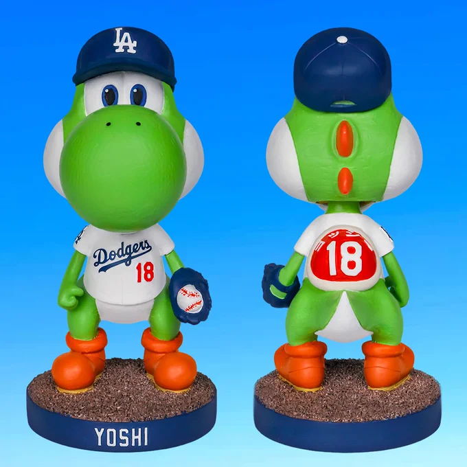 A Yoshi bobblehead wearing a home white Yoshinobu Yamamoto jersey with a Dodgers hat. He wears a red shell backpack.