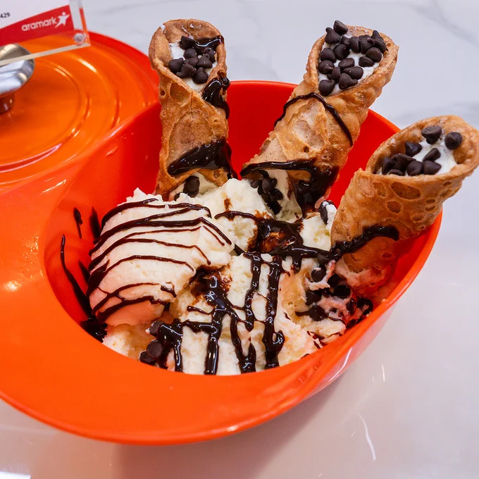 Cannoli and ice cream in an orange batting helmet.