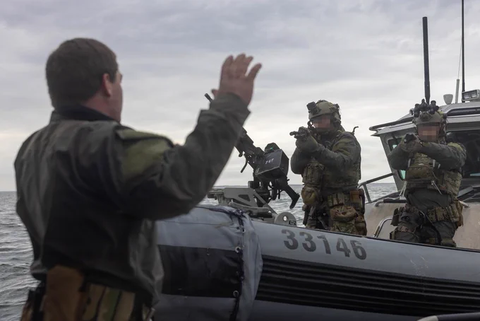 U.S. Coast Guardsmen with the Maritime Security Response Team East apprehend a simulated enemy during an advanced interdiction training exercise in Marine Corps Air Station Cherry Point waterway, North Carolina, Feb. 26, 2026. The MSRT-E is a deployable, specialized force that conducts counterterrorism and direct-action missions. MCAS Cherry Point waterways facilitates crucial maritime training opportunities across the Department of War and the Department of Homeland Security to strengthen the operational readiness of the joint force. (U.S. Marine Corps photo by Lance Cpl. Dillon Anderson)
