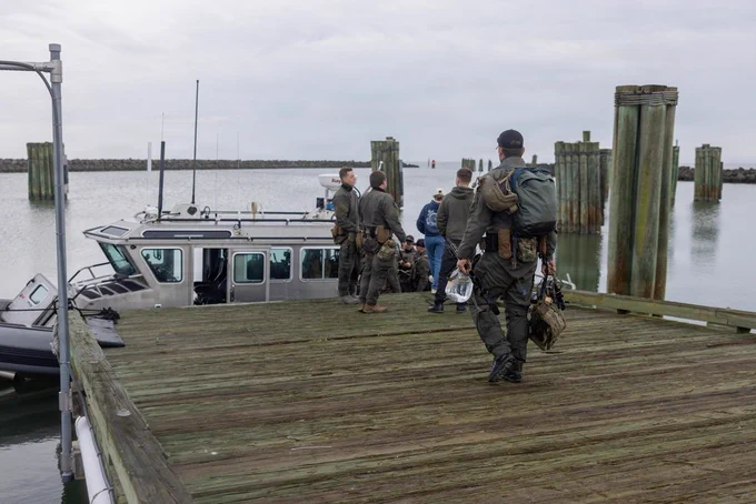 U.S. Coast Guardsmen with the Maritime Security Response Team East pack gear for an advanced interdiction training exercise in Marine Corps Air Station Cherry Point waterways, North Carolina, Feb. 26, 2026. The MSRT-E is a deployable, specialized force that conducts counterterrorism and direct-action missions. MCAS Cherry Point waterways facilitates crucial maritime training opportunities across the Department of War and the Department of Homeland Security to strengthen the operational readiness of the joint force. (U.S. Marine Corps photo by Lance Cpl. Dillon Anderson)