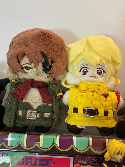 A photo of two hand-made plushies of Pip Bernadotte and Seras Victoria from hellsing. 