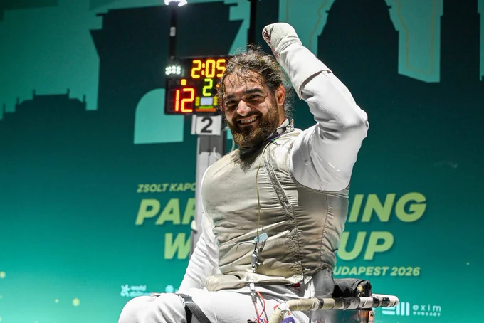 A GBR foil para fencer cheers after a win