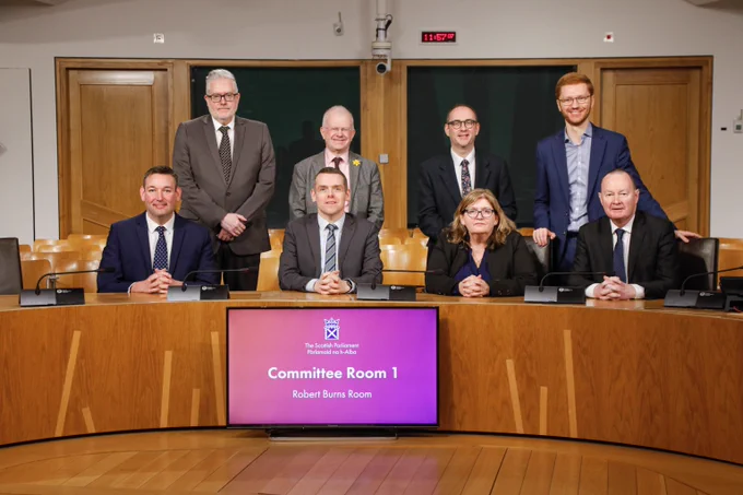 Members of the Education, Children and Young People Committee, (from left to right, back row: George Adam, John Mason, Paul O'Kane, Ross Greer, and front row: Miles Briggs, Douglas Ross - Convener, Jackie Dunbar - Deputy Convener - and Bill Kidd) in Committee Room 1 in the Scottish Parliament. Not pictured: Paul McLennan and Willie Rennie.