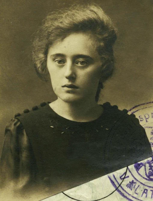 Vintage portrait of a woman in a dark attire, featuring a thoughtful expression.