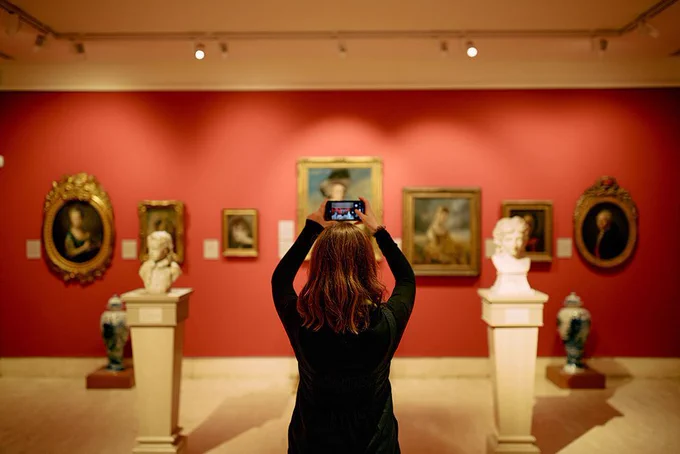 A person taking a photo in a gallery at the Ashmolean Museum