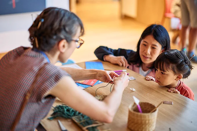 A woman and child take part in a craft activity at the Ashmolean Museum