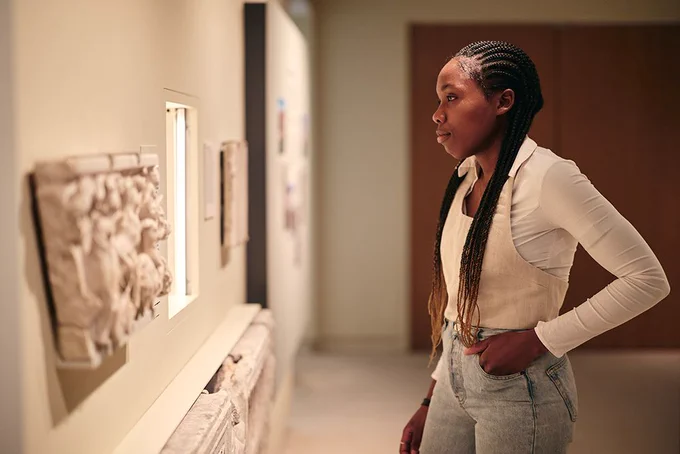 A person looking at an object in the Rome Gallery at the Ashmolean Museum
