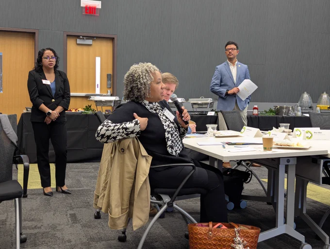 A leadership breakfast attendee speaking during the Q&A session