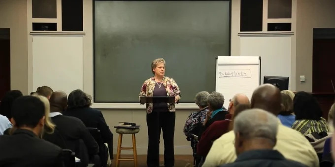 screen snip from a digitized video recording of Dr. Nancy Lammers Gross delivering her response to Earl Palmer's preaching during The Exposition Seminar I: The Joy of Expositional Preaching, November 5, 2015; Dr. Lammers Gross speaking in front of a room of seminar attendees