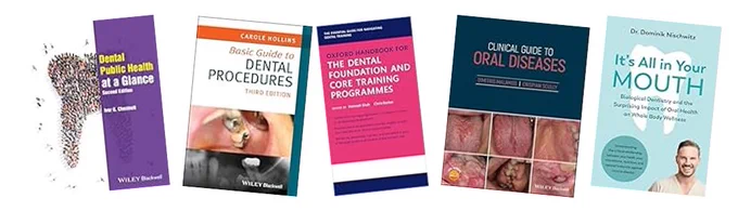 Five dental book covers arranged horizontally, with scattered tooth-like granules in the lower left foreground. From left to right: - "Dental Public Health at a Glance, Second Edition" (purple) - "Basic Guide to Dental Procedures, Third Edition" by Carole Hollins (orange, showing dental tools in mouth) - "Oxford Handbook for the Dental Foundation and Core Training Programmes" (pink/blue) - "Clinical Guide to Oral Diseases" (dark teal, with oral lesion photos) - "It's All in Your Mouth" by Dr. Dominik Nischwitz (biological dentistry & whole-body health focus) Promotional dentistry book display against a plain background.