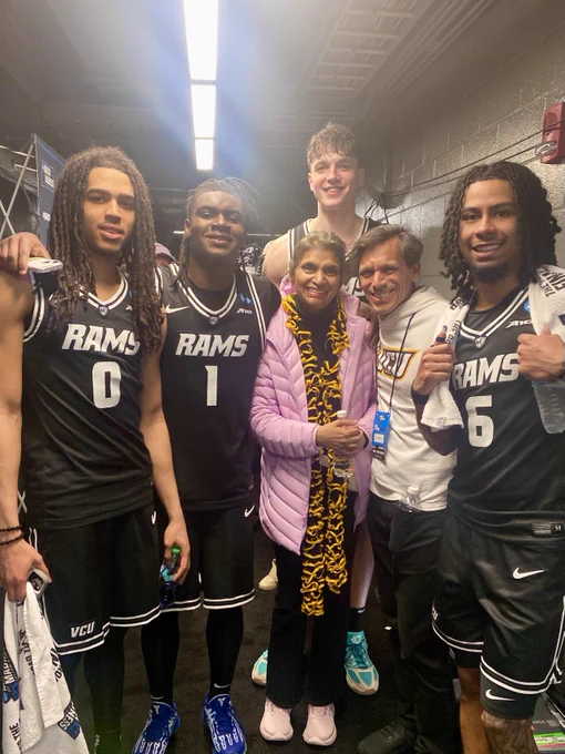 Dr. Rao and Monica Rao pose with four members of the V-C-U men's basketball team. Everyone is smiling.