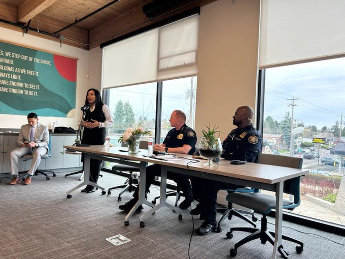 Photo of Chief and another officer and Councilor Smith at coffee with a cop event