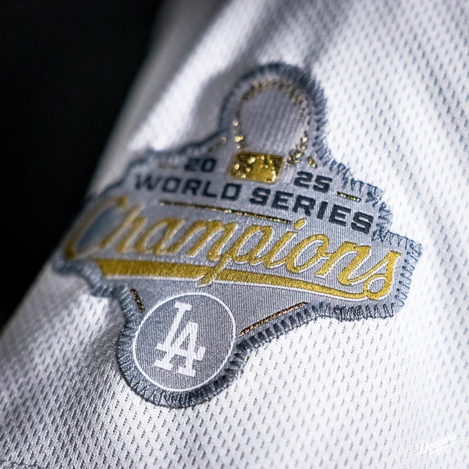 A photo of the Dodgers 2025 World Series Champions patch on the Dodgers gold jersey.
