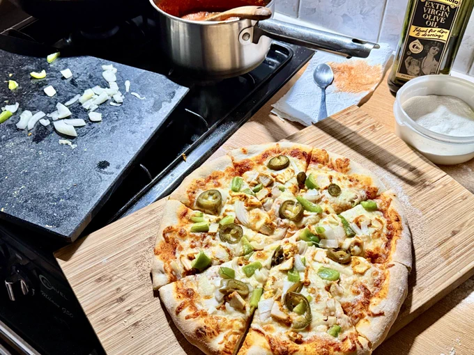 Homemade pizza on a wooden bread board