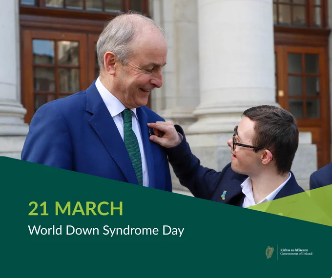 Image of Taoiseach Micheál Martin with a member of Down Syndrome Ireland at at Government Buildings, March 2026.  Text reads:  21 March World Down syndrome Day.  Logo of Government of Ireland.  
Photograph: Government Information Service