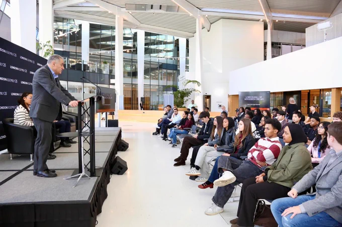Man speaking to group of young people.