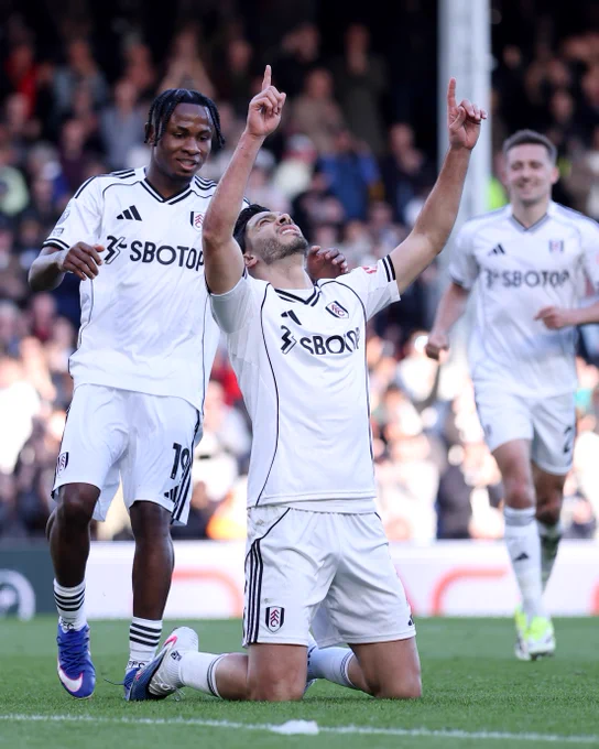 Raúl Jiménez falls to his knees and points to the sky with both hands after scoring his penalty against Burnley.