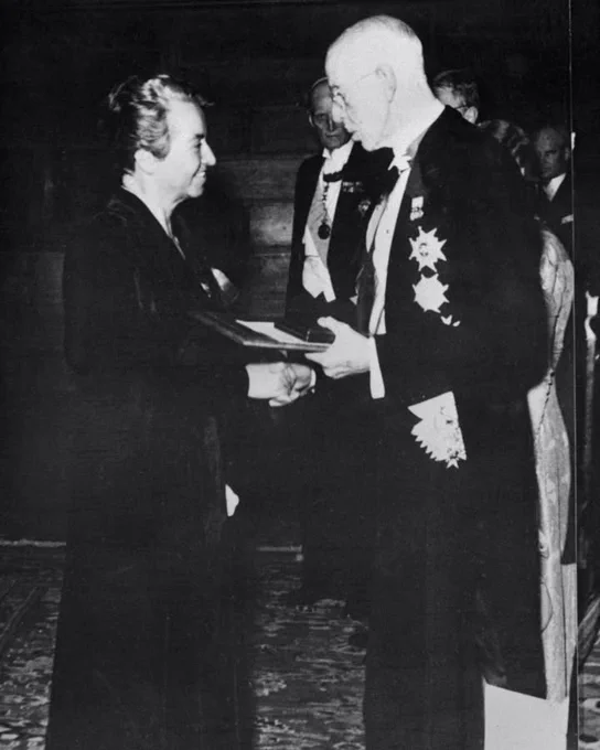 Photograph of Gabriela Mistral receiving her Nobel Prize medal and diploma.