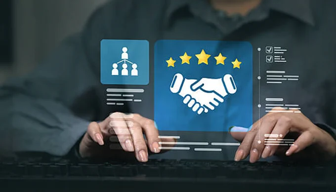 A person typing on a keyboard with a holographic display showing a handshake icon and five-star rating, symbolizing customer loyalty and trust.