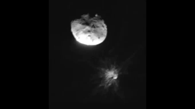 View from the Italian Space Agency ASI's LICIACube CubeSat, which travelled along with NASA's DART mission to capture the spacecraft's collision with the Dimorphos asteroid. In this LICIACube image, taken moments after impact, debris fans out from the smaller asteroid towards its larger partner, Didymos.