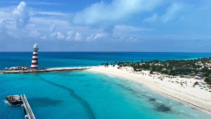 Lighthouse in the Caribbean Islands with crystal clear blue seas an sunny blue skies X