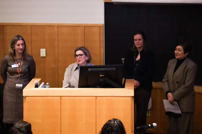 Four people speak at podium