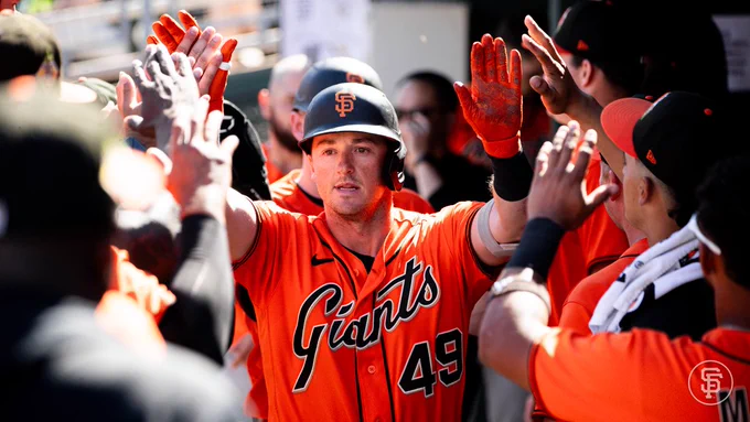 Tyler Fitzgerald high fives in the dugout