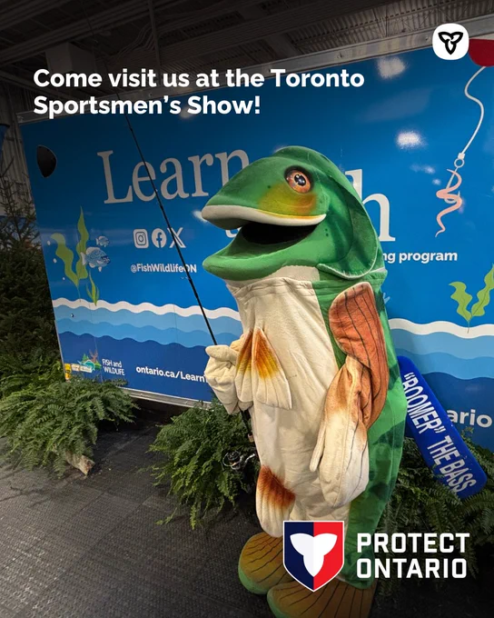 Boomer the Bass posing with a fishing rod, Text reads “Come visit us at the Toronto Sportsmen’s Show!