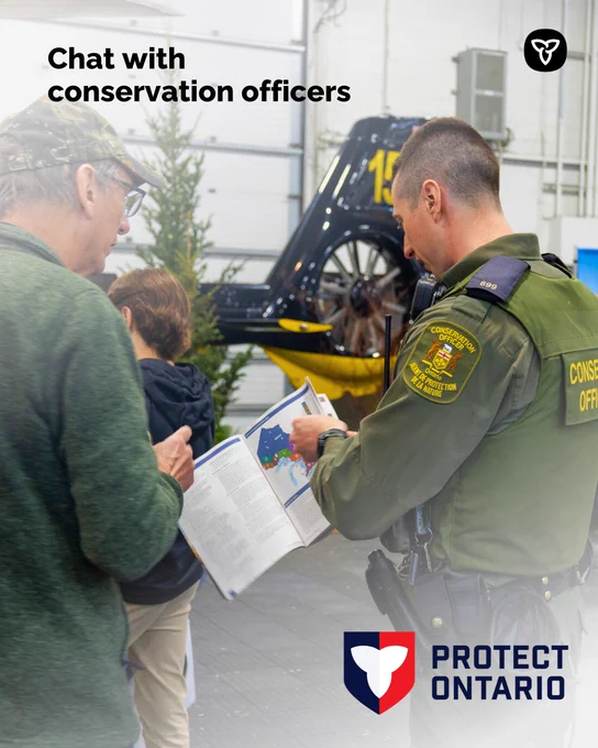  A conservation officer showing an individual the hunting regulations summary, Text reads “Chat with conservation officers