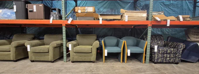Various lounge chairs lined up under racking at Surplus