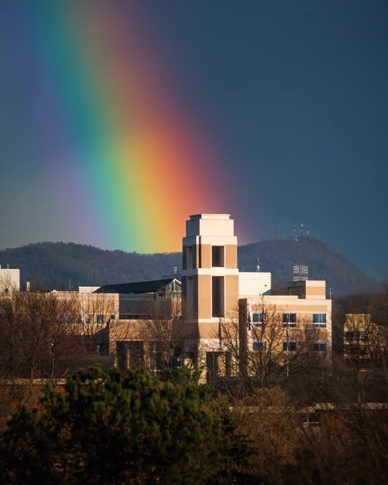 A rainbow over East Campus of James Madison University at dusk.