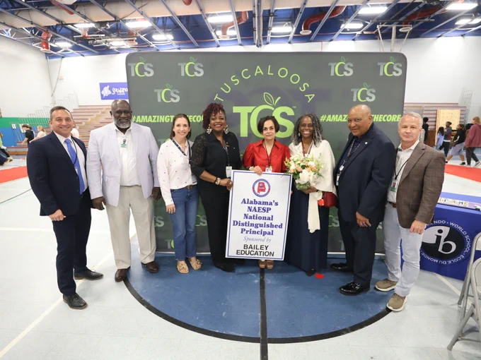 Principal Dr. Preeti Nichani stands with Tuscaloosa City Schools Board of Education after presentation.