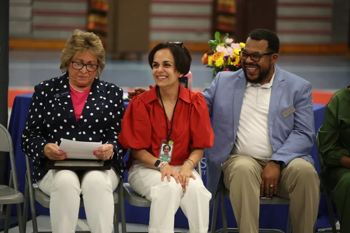 Principal Dr. Preeti Nichani smiling with sitting with award staff.