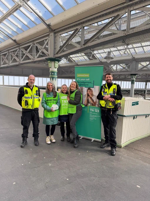 A photograph of Samaritans volunteers and the British Transport Police at Lewes train station