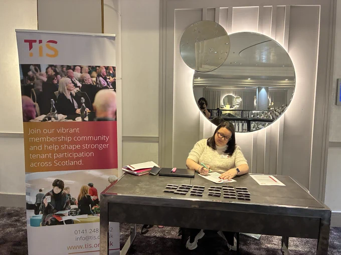 Jill, TIS Office Manager welcoming delegates to Connected for Change at the Hilton Hotel in Glasgow.