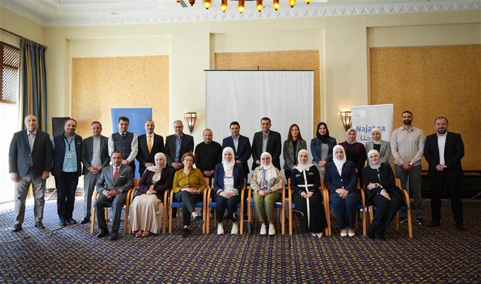Representatives from Plan International Jordan, the Ministry of Education, and partner organization Quetscope pose for a group photo during a workshop on strengthening monitoring and coordination for the Dropout Education and Learning Programme.