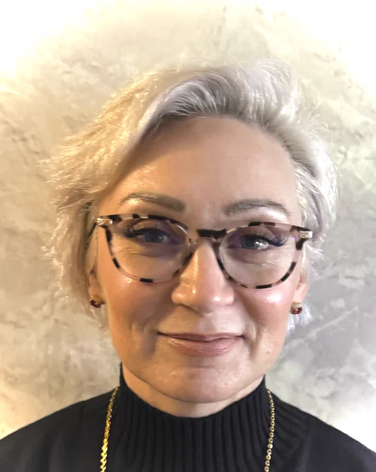 JessicaRae Rivera, a behavioral health continuing education student who has short blonde hair and is wearing tortoise shell classes. 