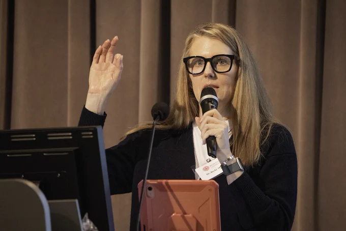 Event photo from the 2026 Langford Conference. Image depicts a speaker gesturing and talking into a microphone behind a podium. 