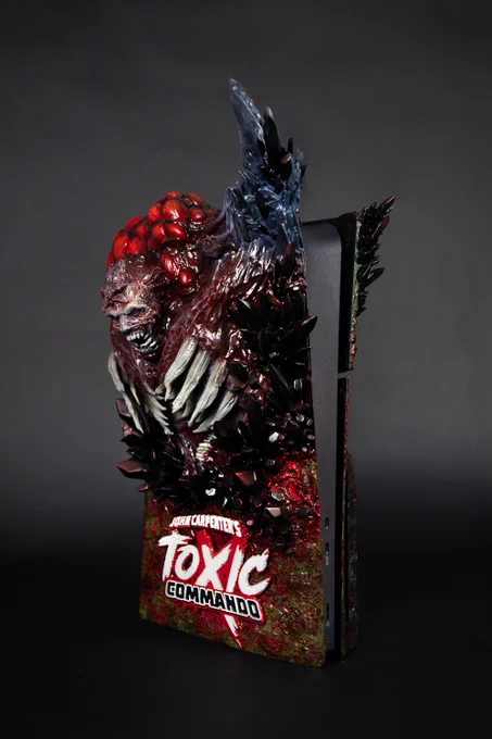 Custom John Carpenter's Toxic Commando PS5 and controler with the game's logo and an iconic enemy from the game on it.
