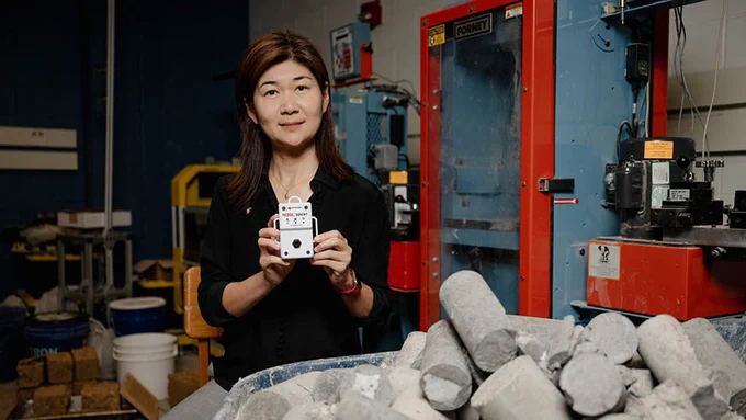 Luna Lu, Wavelogix founder and Purdue University professor, holds the Rebel concrete strength sensing system, which her lab invented to improve estimates of in-place strength of concrete structures. Wavelogix has received a $500,000 Phase IIB grant to develop the technology.