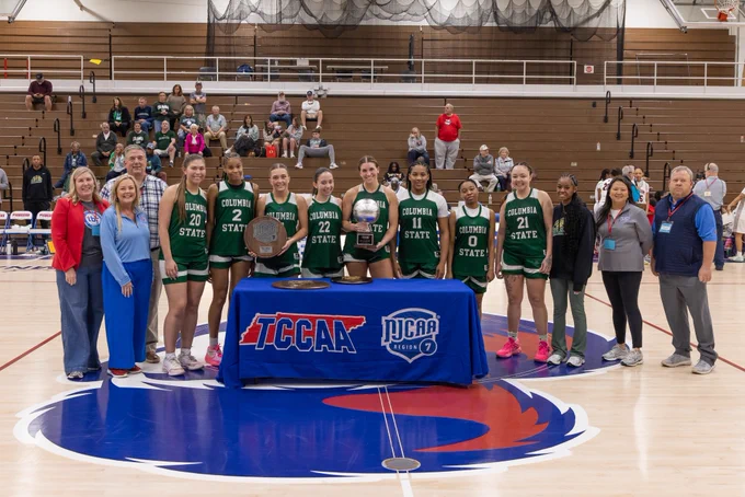 Image of the women’s runners up, Columbia State Community College, on the basketball court holding their awards.