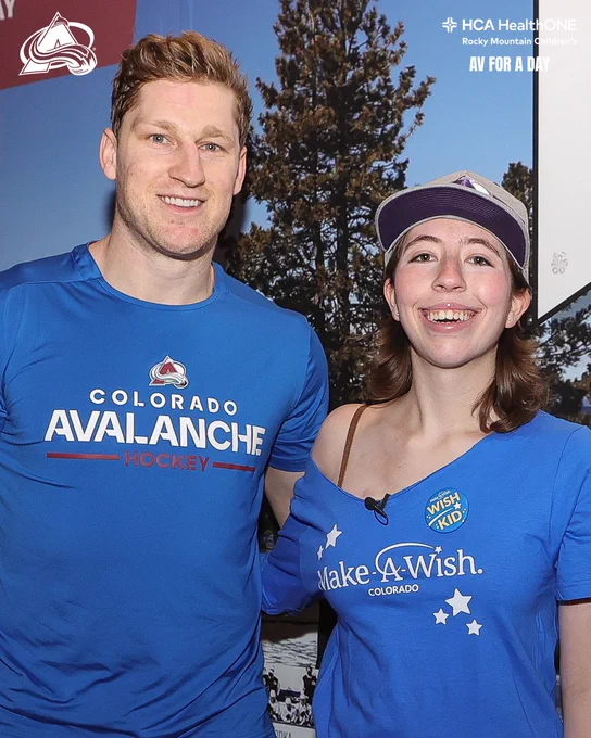 Nathan MacKinnon meeting with Sabrina in the Avalanche hallway as they take a photo together